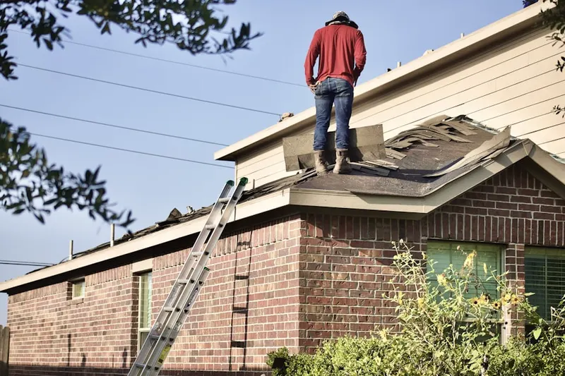 Professional roofer working on a residential roof in Cypress